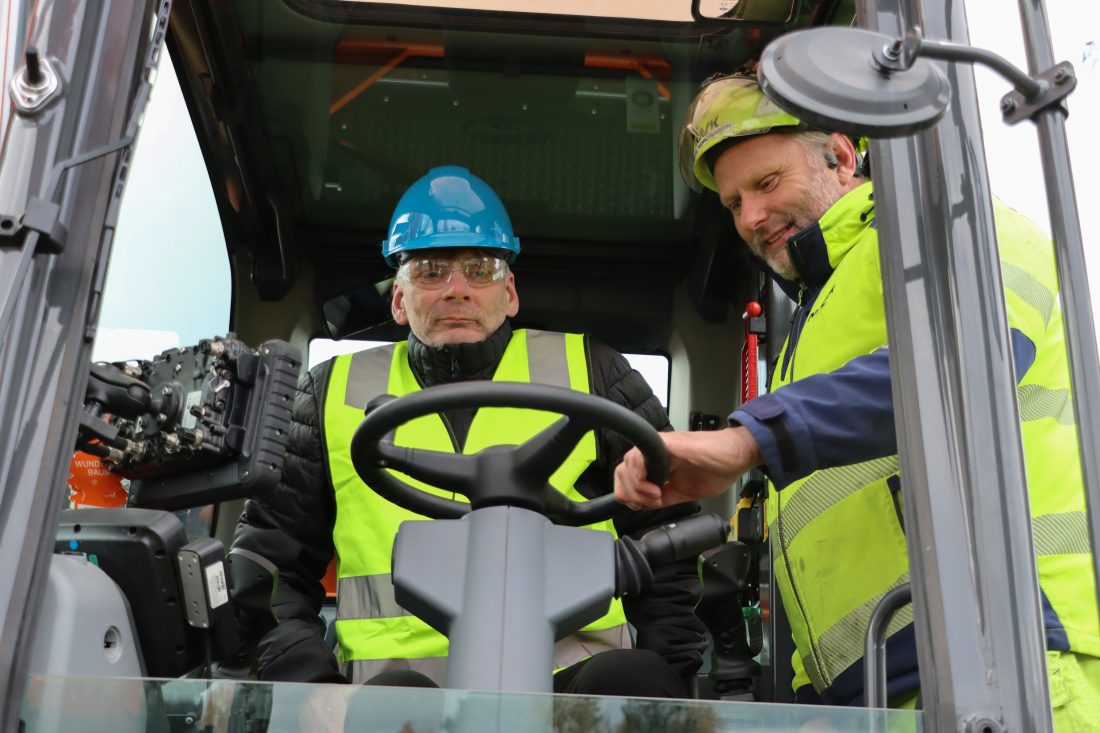 Trygve Småge måtte prøvekjøre el-graveren, og hadde en del spørsmål som Pål Nordhagen svarte på etter beste evne. (Foto: Njål Hagen)